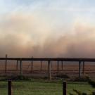 fence line with smoke in background