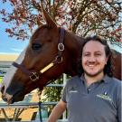 Dr. Camilo Jaramillo-Morales standing next to a horse